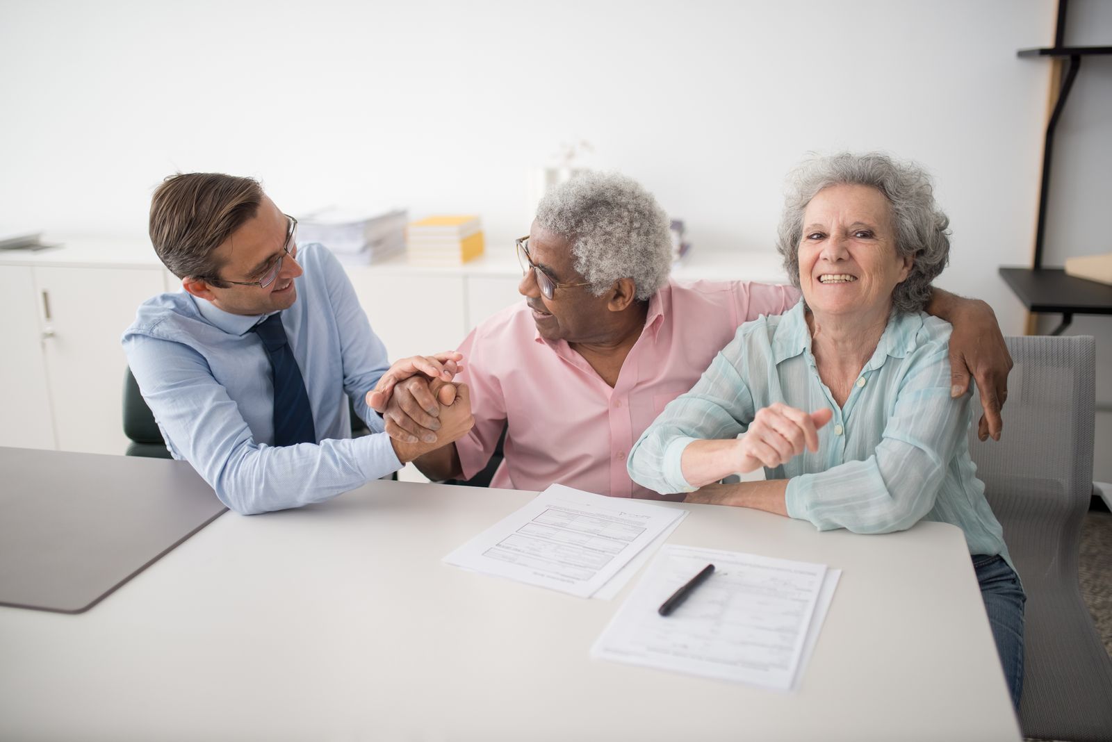 An insurance agent walking a smiling couple through their options